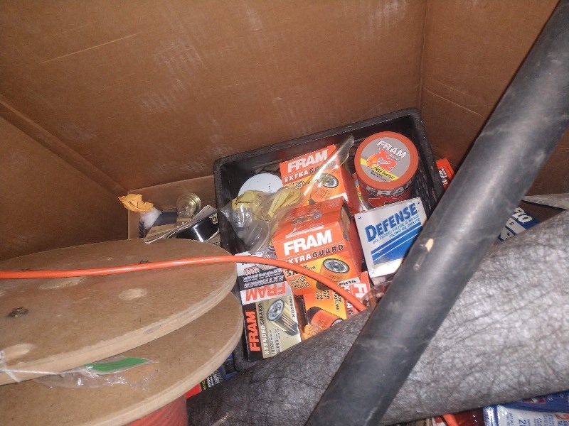 lot 88 image: Spool of Orange Fiber Optic Cable, Fuel and Oil Filters, Anchor Points, Car Stereo Replacement Parts, Gasket Sealant, and Other Accessories