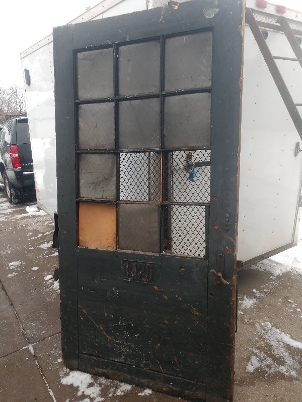 lot 128 image: Architectural Antique Wood Door with Twelve Glass Panels and Lined with Wire Fencing (Some Glass Missing)