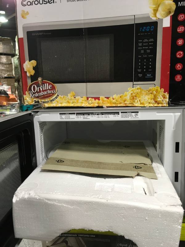 lot 94 image: Sharp Carousel 1.1 cu. ft. Countertop Microwave in Stainless Steel with Orville Redenbachers Popcorn Preset not used