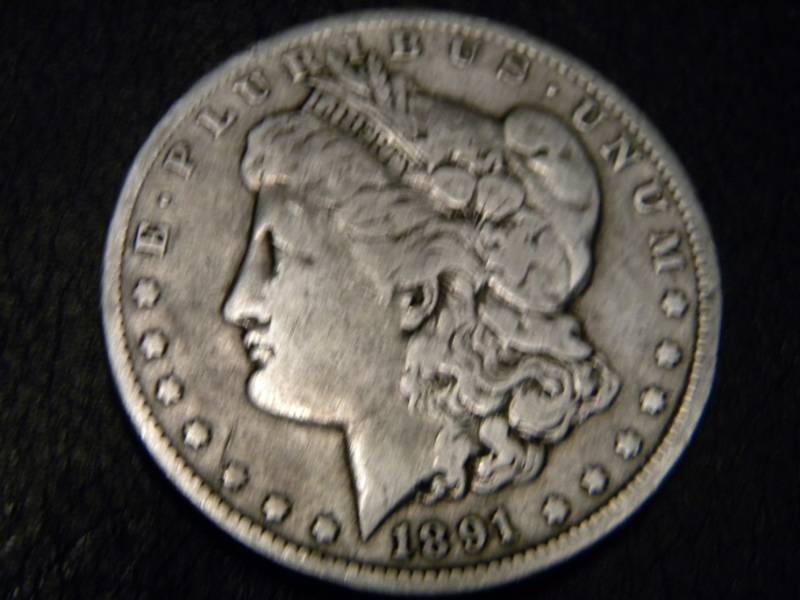 lot 24 image: 1891 O Morgan Silver Dollar