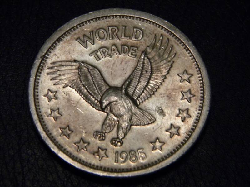 lot 25 image: 1985 World Trade Unit- One Troy Ounce .999 Silver