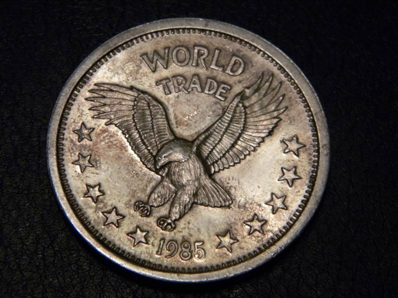 lot 26 image: 1985 World Trade Unit- One Troy Ounce .999 Silver