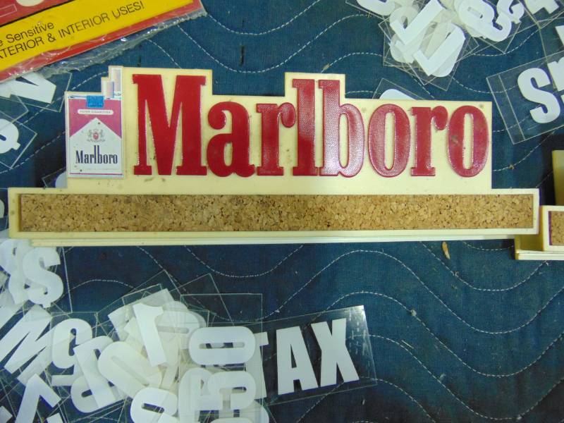 lot 91 image: (2) Marlboro Clips and Other Advertising Items