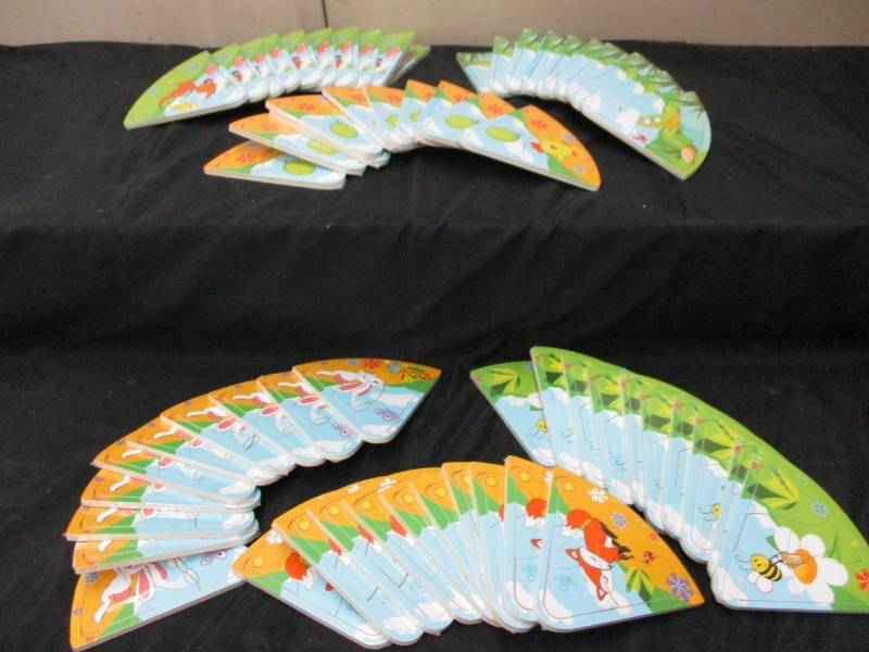lot 215 image: 60 Mini Puzzles will make great stocking stuffers or use for a game Unopened and sealed in plastic so you could sell them