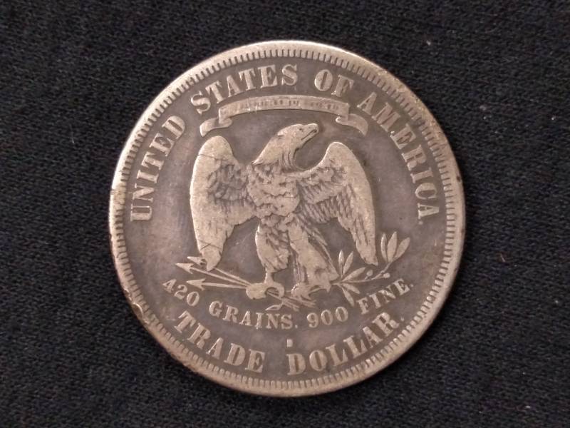 lot 5 image: 1877 S Trade Silver Dollar...