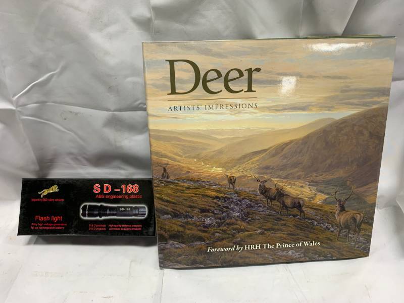 lot 56 image: Stun Gun Flashlight & Deer Book
