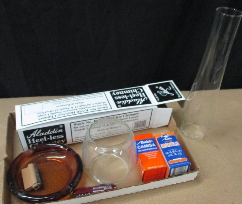 lot 17 image: Alladin chimney and other alladin supplies new in box, army knife and more.