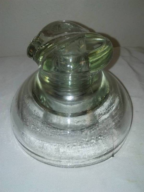lot 56 image: 5.5 inch clear glass insulator.