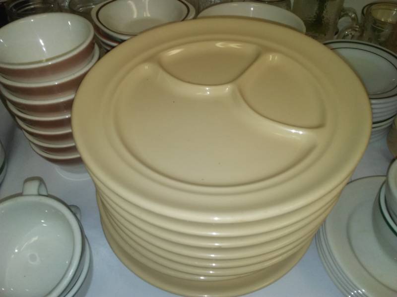 lot 59 image: Miscellaneous dinnerware items Buffalo China plates, Pyrex Green Stripe, dessert plates and more.