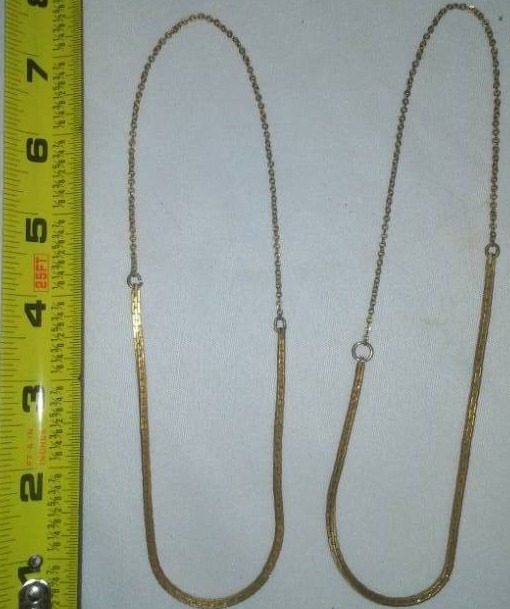 lot 63 image: 2 gold tone necklaces uncertainty of carat weight or purity.