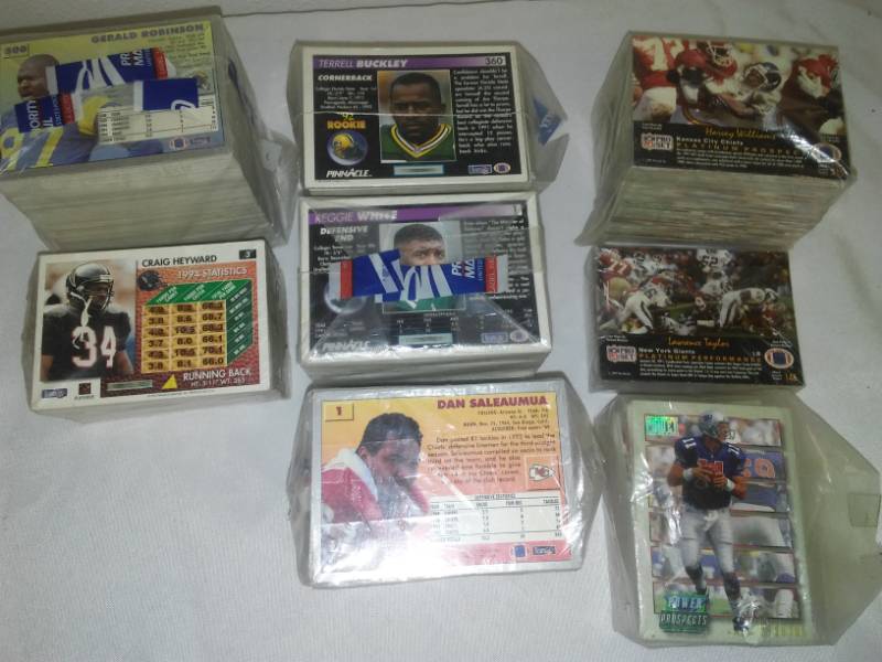 lot 88 image: NFL cards to sets plus. 93 Fleer 1 - 500, 92 can I call 1 - 360, 91 pro set 4 - 315, Drew Bledsoe Rookie. 19in of cards.