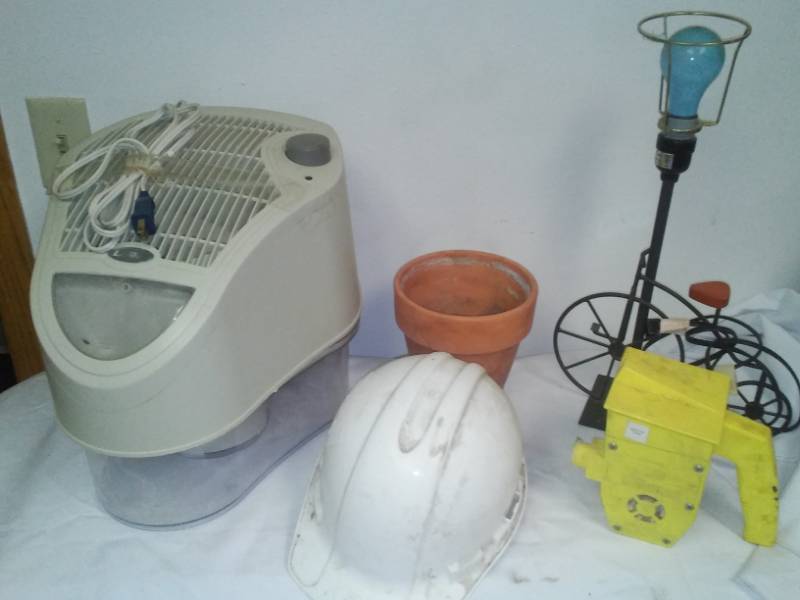 lot 106 image: Lasko humidifier and more. Hard hat, lamp, Seeder.