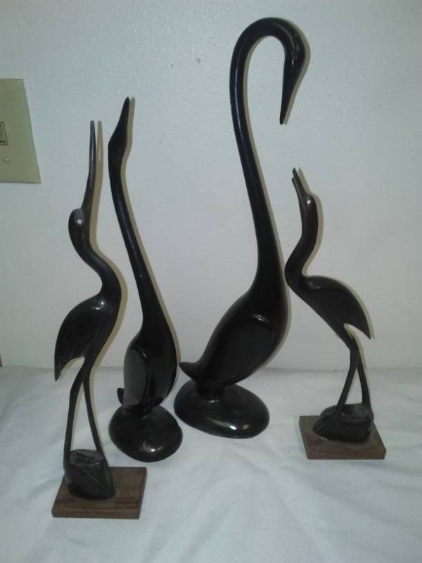 lot 113 image: Swans - 4 cast and wood.