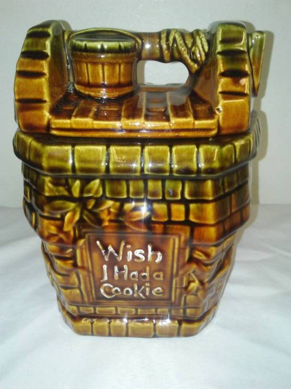 lot 123 image: Vintage McCoy ceramic cookie jar wish I had a cookie Wishing Well cookie jar. One new line.