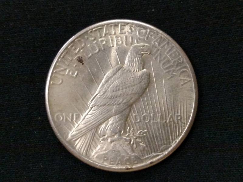 lot 24 image: 1925 AU Peace Silver Dollar...