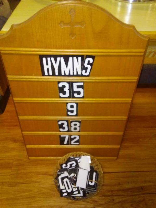 lot 33 image: Hymnal placard with letters and numbers.