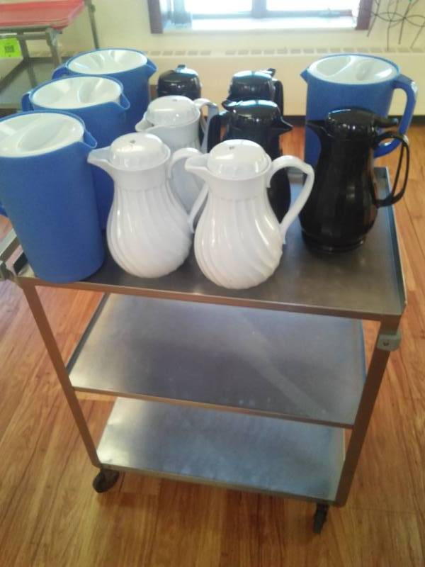 lot 91 image: Black and white hot  cold servers - 7 and Rubbermaid pitchers - 4 with stainless steel cart.