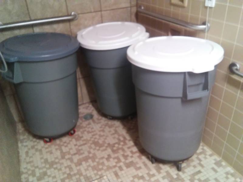 lot 532 image: Three garbage cans on roller carts.