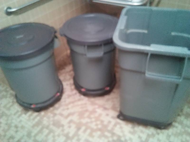 lot 533 image: Three garbage cans on roller carts.