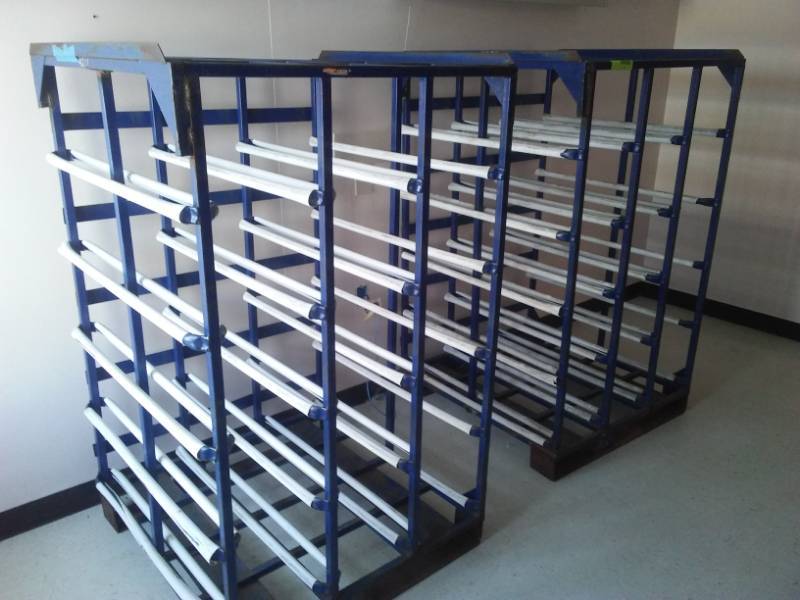 lot 137 image: 2 steel racks designed to hold 5 gallon water jugs.
