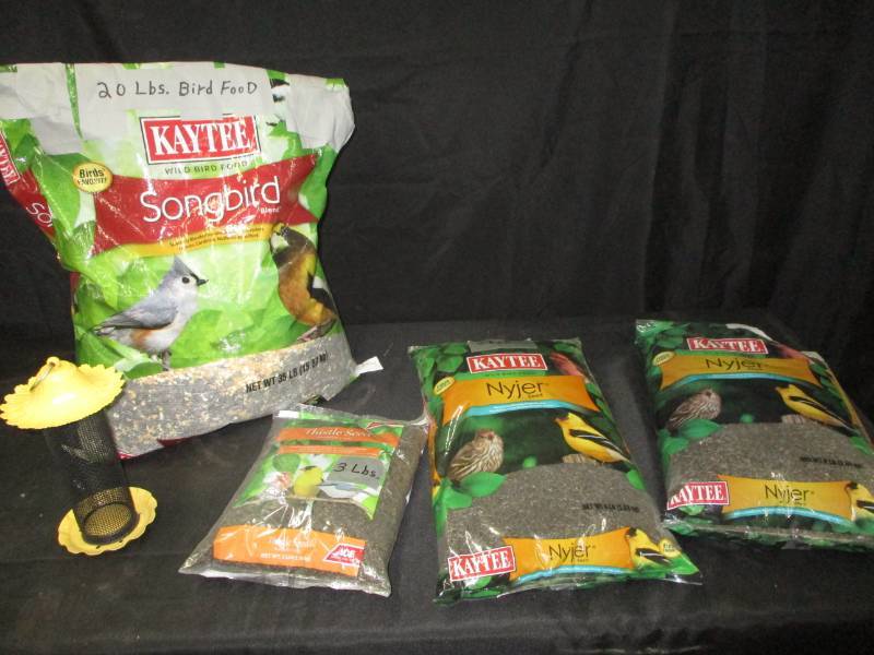 lot 33 image: 38 lbs lbs of bird food, 18 lbs. of Thistle feed plus feeder and 20 lbs of wild bird seed,