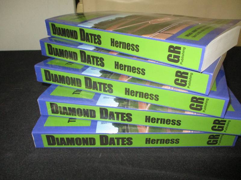 lot 97 image: 5 Count Diamond Date The Baseball Birthday Books Signed by Author Glen Herness. Field on front is the Fergus Falls Baseball Complex at Delagoon