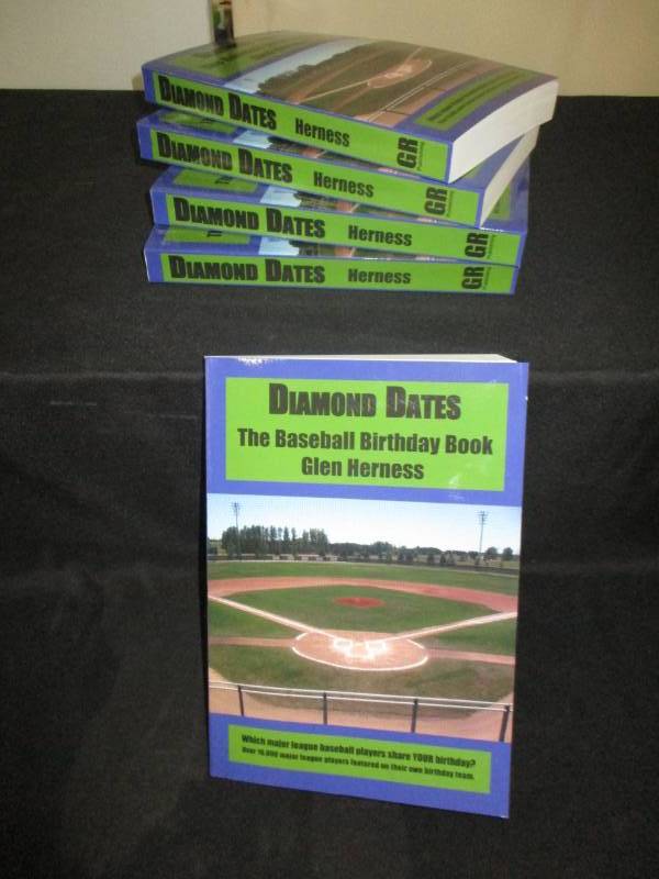 lot 99 image: 5 Count Diamond Date The Baseball Birthday Books Signed by Author Glen Herness. Field on front is the Fergus Falls Baseball Complex at Delagoon