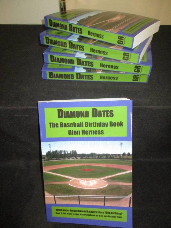 lot 100 image: 5 Count Diamond Date The Baseball Birthday Books Signed by Author Glen Herness. Field on front is the Fergus Falls Baseball Complex at Delagoon