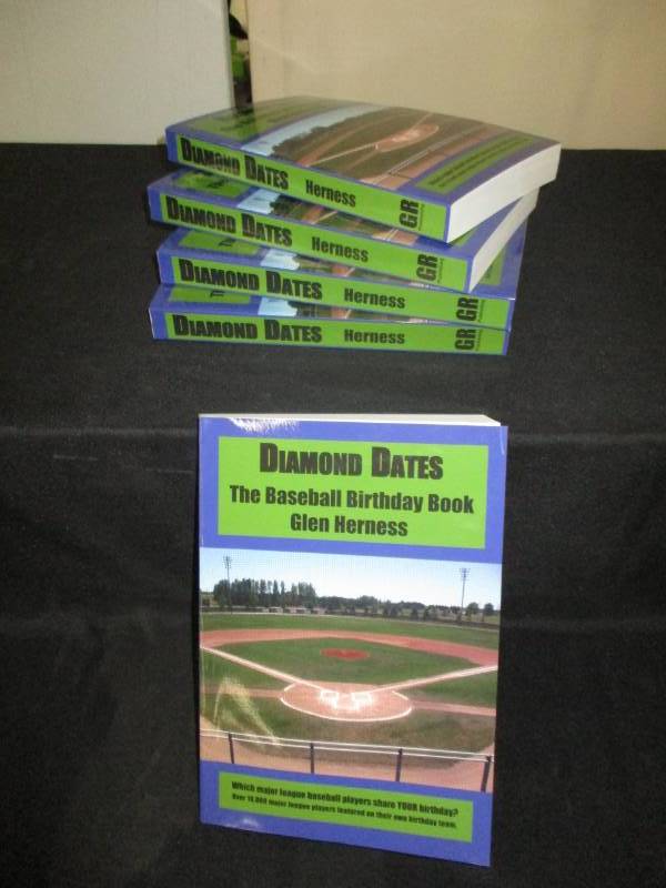 lot 101 image: 5 Count Diamond Date The Baseball Birthday Books Signed by Author Glen Herness. Field on front is the Fergus Falls Baseball Complex at Delagoon
