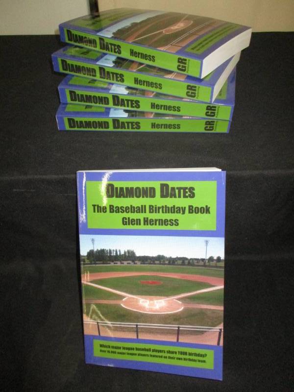 lot 103 image: 5 Count Diamond Date The Baseball Birthday Books Signed by Author Glen Herness. Field on front is the Fergus Falls Baseball Complex at Delagoon
