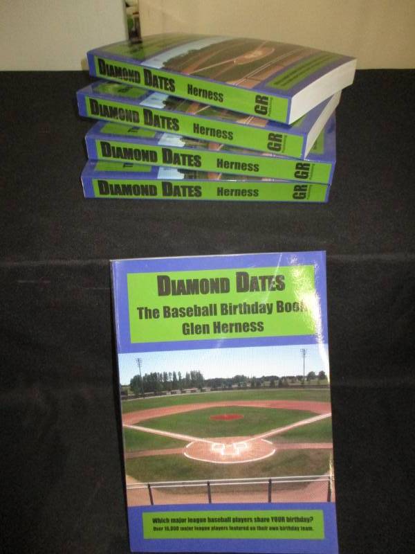 lot 104 image: 5 Count Diamond Date The Baseball Birthday Books Signed by Author Glen Herness. Field on front is the Fergus Falls Baseball Complex at Delagoon