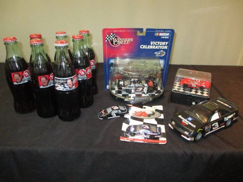 lot 181 image: Dale Earnhardt Pop bottles full, Stack of note paper, cap, cars, collector nascar cars and more