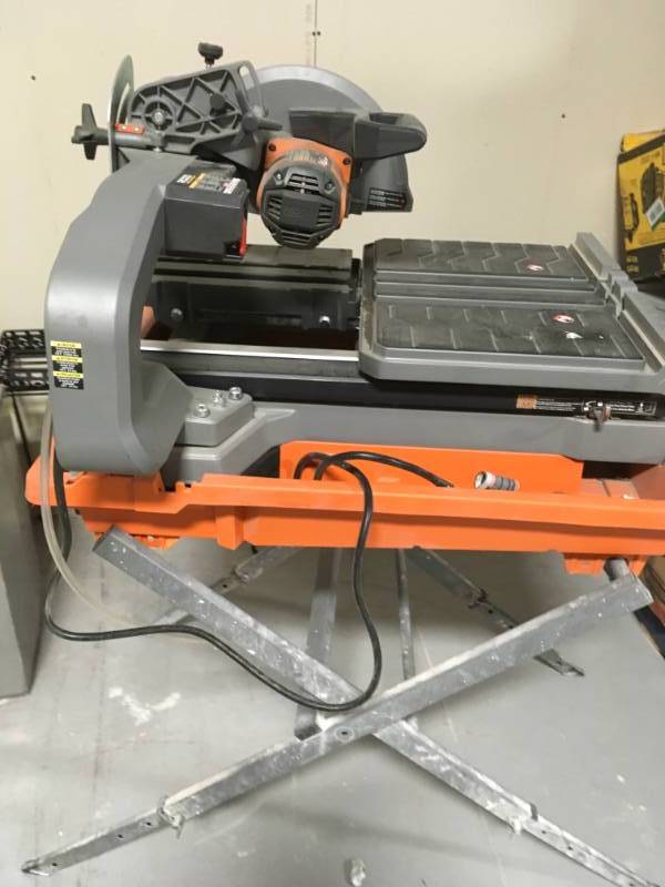 RIDGID  10 in. Wet Tile Saw used with Stand  in working conditions