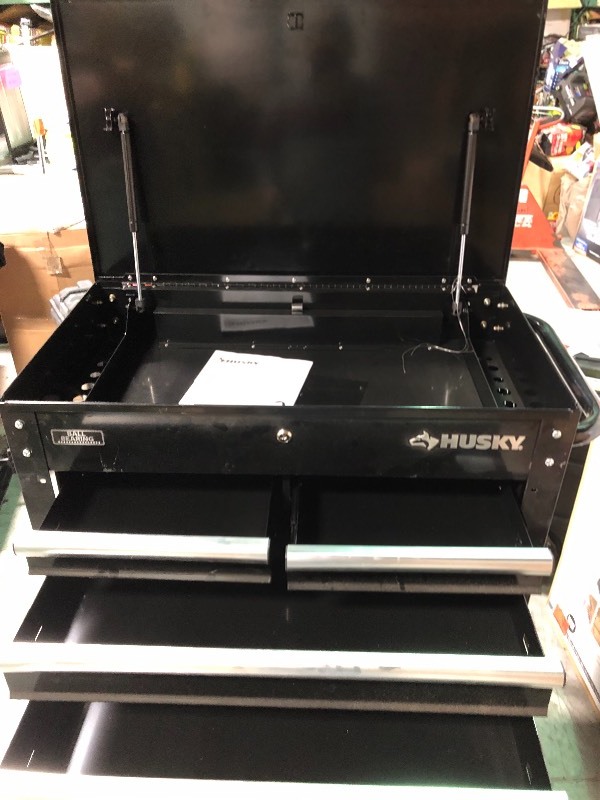 lot 107 image: Husky  33 in. 4-Drawer Mechanics Tool Utility Cart in Black have some scratchs and dents  missing lock in decent conditions