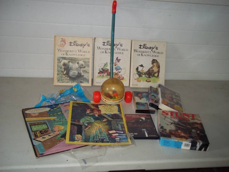 lot 85 image: Disney Books Puzzles and unopened VHS Childrens tapes