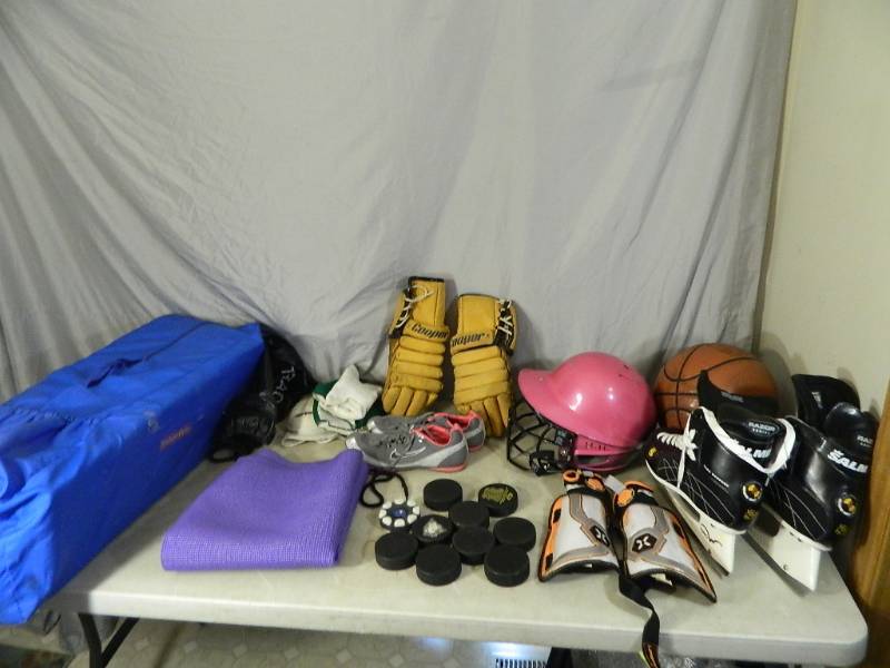 lot 132 image: Hockey Skates, Pucks, Softball Helmet, Track Shoes, and More