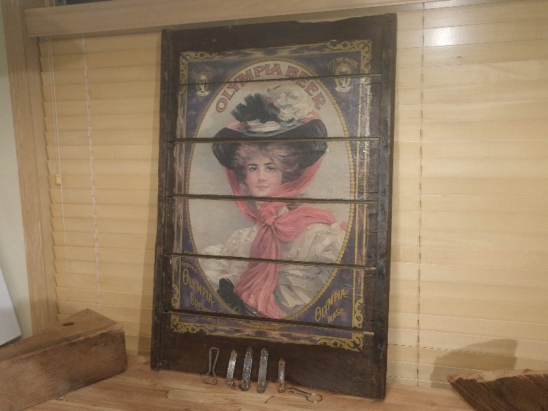 lot 102 image: Olympia Brewing Co. Brewery Girl Wooden Plank Sign and Six Vintage Bottle Openers