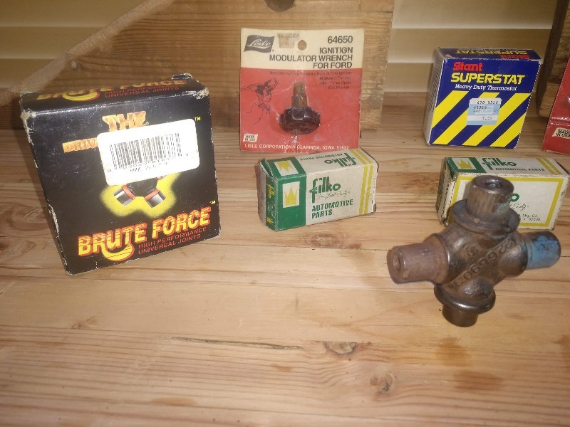 lot 140 image: One Hub Cap, Ignition Modulator Wrench for Ford, Fan Belt Tightener and Other Automotive Parts