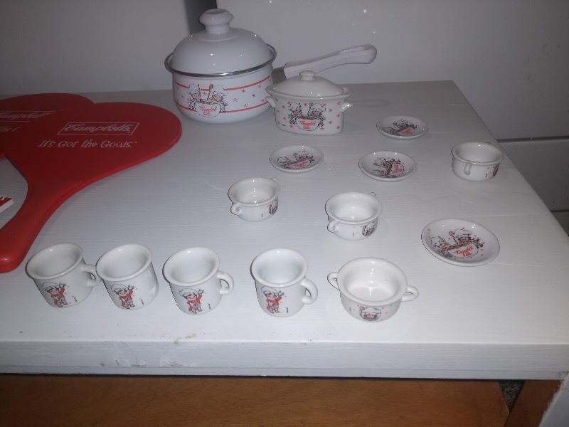 lot 176 image: Campbells Lunchbox with Tea Set, Vintage Campbells Sauce Pan, Two Campbells Paddles, Campbells Mousepad, Campbells Pencils and Notepad