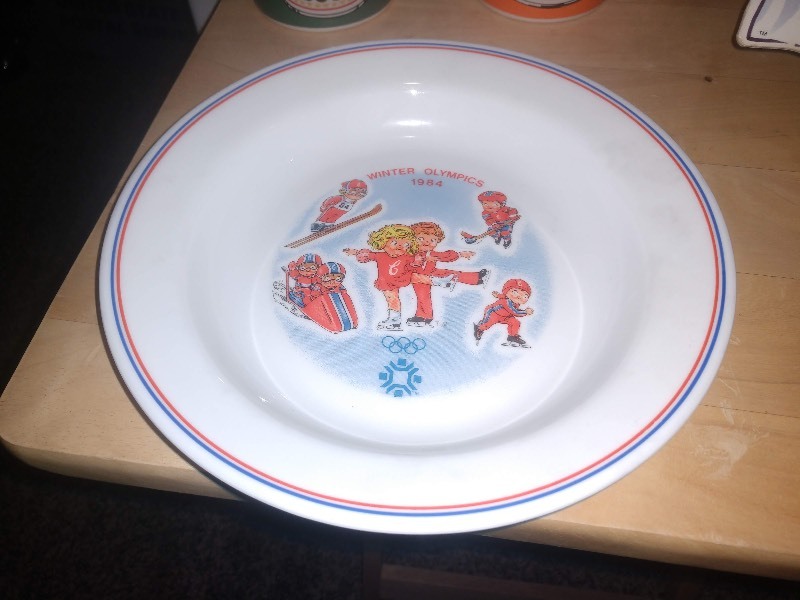 lot 178 image: One Cardboard Campbells Kid, Two Campbells Andy Warhol Mugs and One Campbells 1984 Winter Olympics Plate