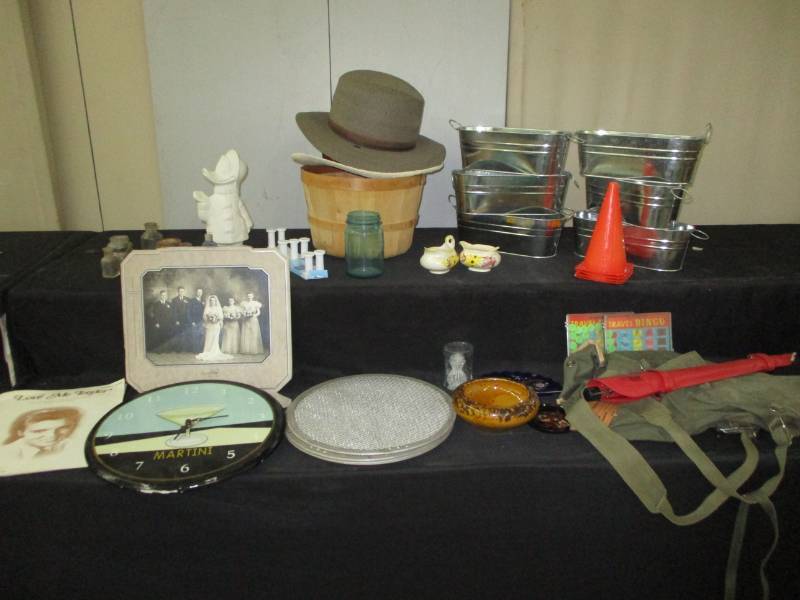 lot 78 image: Martini clock, unbrells, army bag, metal tubs, jars old bottles, Wedding picture, Elvis love Me Tender Music