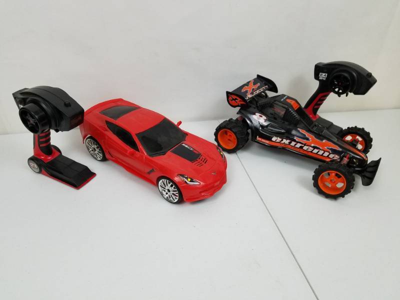 lot 90 image: 2 Remote Control cars with remotes by Maisto