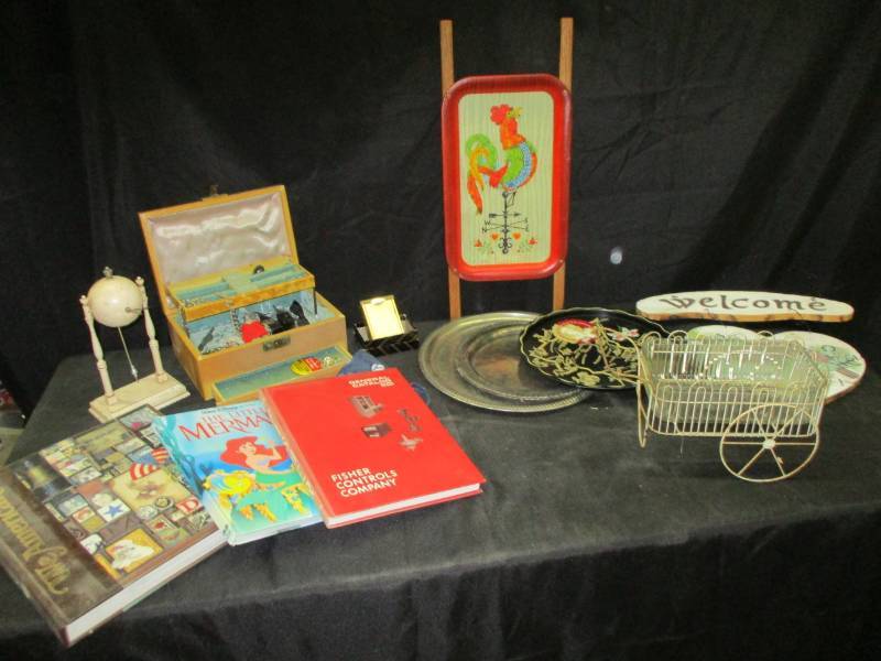 lot 121 image: We Americans Book, disney book, Fisher Controls Company book, bread pan holder, chicken tray, welcome sign, jewelry, unique clock, marbles and more