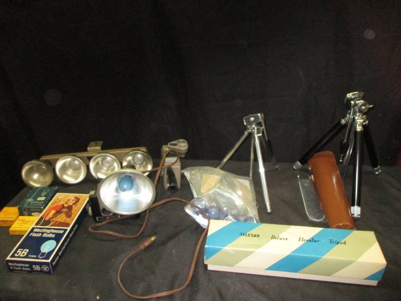 lot 151 image: Old Camera Equiptment, Brownie Hawkeye camera and Bell and Howell and tripods, flash bulbs, lights and more
