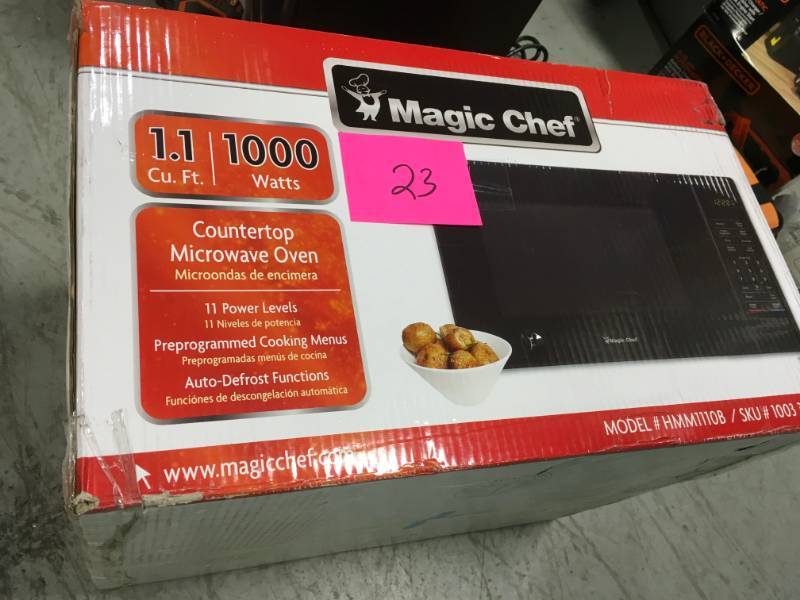 lot 23 image: Magic Chef 1.1 cu. ft. Countertop Microwave in Black with Gray Cavity open box in like new condition