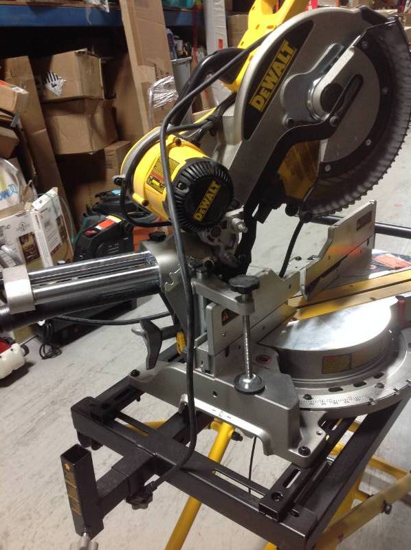 lot 106 image: DEWALT 15-Amp Corded 12 in. Sliding Compound Miter Saw with Bonus Rolling Stand USED IN WORKING CONDITIONS STAND MISSING ONE BRAKET