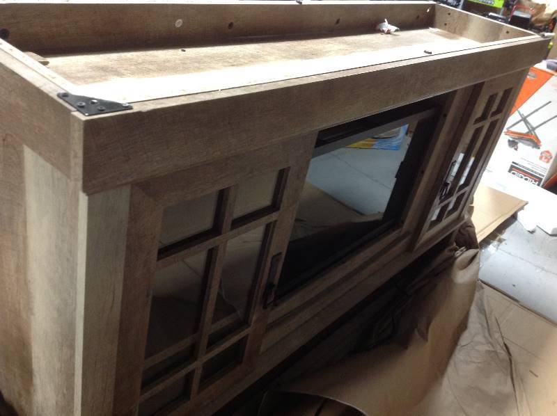lot 102 image: Oak fireplace tv stand in working conditions whit damage on the botton part