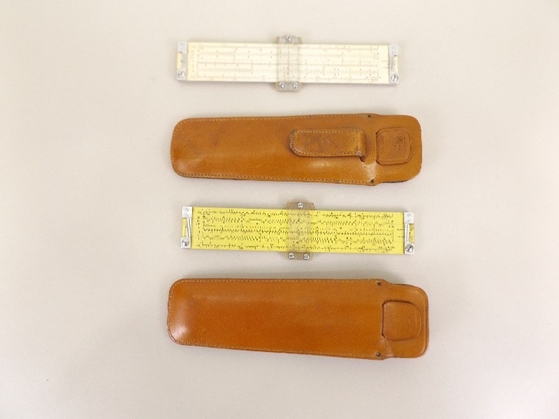 lot 26 image: 2 Collectible Pickett Slide Rules in Leather Cases