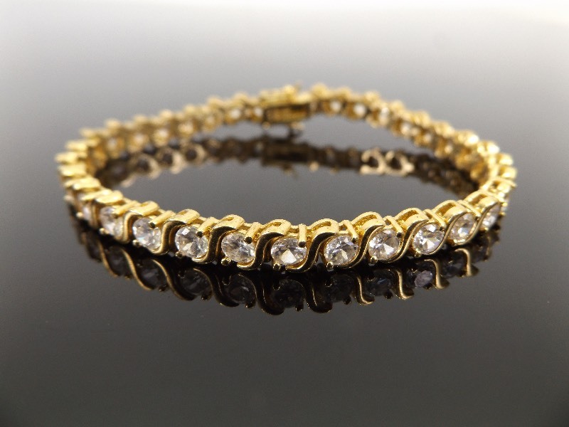 lot 74 image: Yellow Gold Washed .925 Sterling Silver 7 Crystal Tennis Bracelet