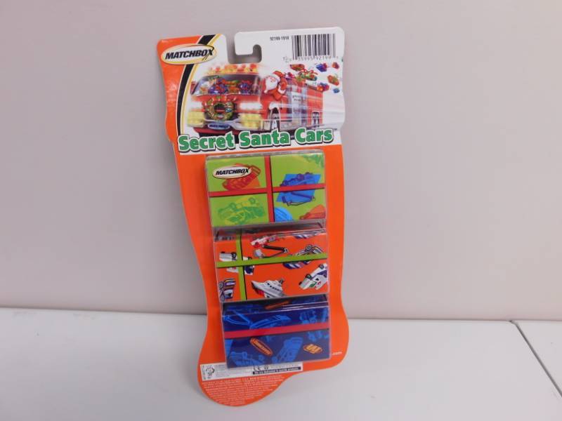 lot 114 image: Three New in Package Secret Santa Matchbox Cars